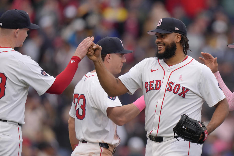 Boston Red Sox's Kenley Jansen, right, celebrates with Garrett Cooper, left, and Romy Gonzalez, center, after they defeated the Washington Nationals in a baseball game, Sunday, May 12, 2024, in Boston. (AP Photo/Steven Senne)