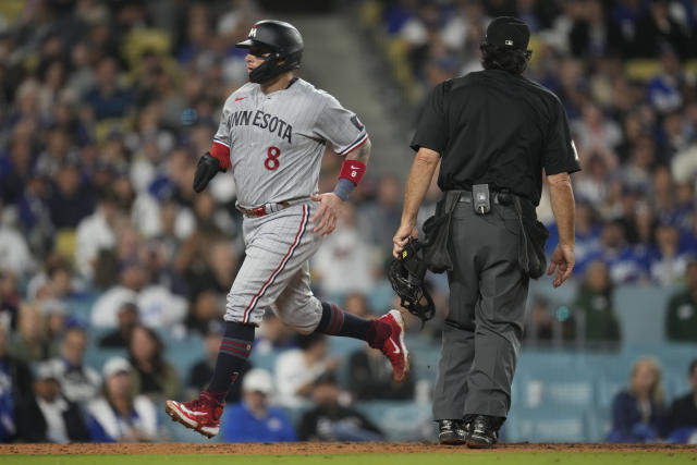 Minnesota Twins' Christian Vazquez (8) scores off of a wild pitch by Los Angeles Dodgers relief pitcher Caleb Ferguson during the seventh inning of a baseball game in Los Angeles, Monday, May 15, 2023. (AP Photo/Ashley Landis)