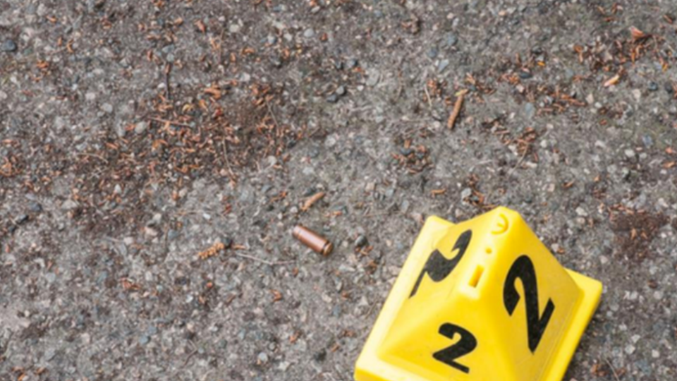 Bullets on the ground and a bright yellow cone places next to it