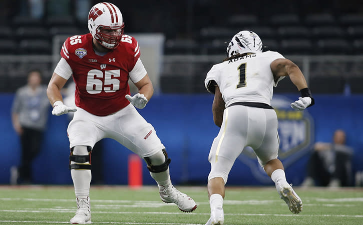 Jan 2, 2017; Arlington, TX, USA; Wisconsin Badgers offensive lineman Ryan Ramczyk (65) blocks Western Michigan Broncos defensive end Keion Adams (1) in the third quarter at AT&T Stadium. The Badgers won 24-16. Mandatory Credit: Tim Heitman-USA TODAY Sports