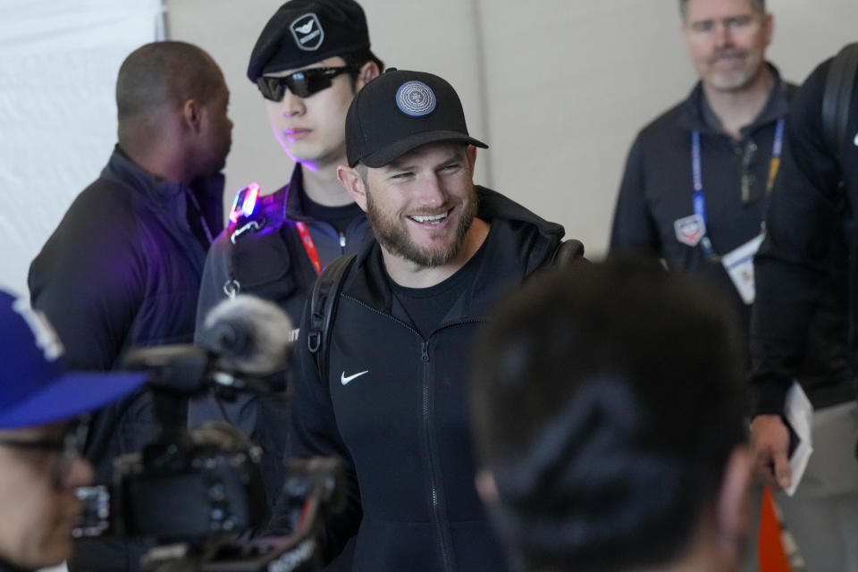 Los Angeles Dodgers' Max Muncy reacts as he is greeted during the baseball team's arrival at Incheon International Airport, Friday, March 15, 2024, in Incheon, South Korea, ahead of the team's baseball series against the San Diego Padres. (AP Photo/Ahn Young-joon)