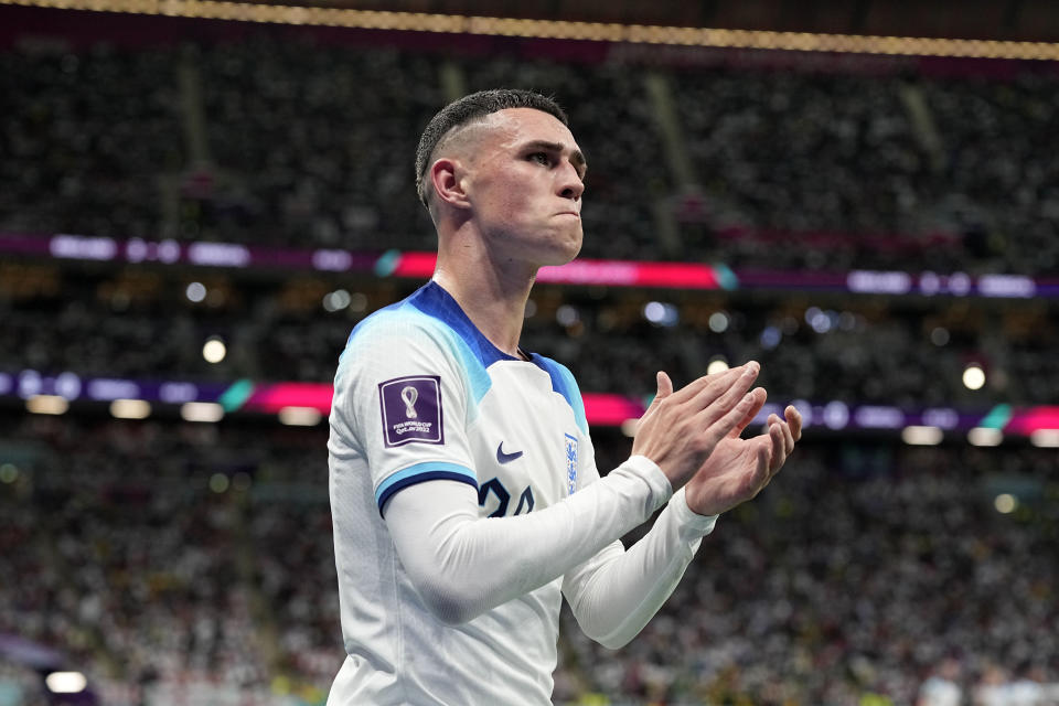 England's Phil Foden claps hands as he is leaving the pitch during the World Cup round of 16 soccer match between England and Senegal, at the Al Bayt Stadium in Al Khor, Qatar, Sunday, Dec. 4, 2022. (AP Photo/Abbie Parr)