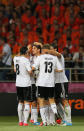 KHARKOV, UKRAINE - JUNE 13: Mario Gomez of Germany celebrates scoring the opening goal with team mates during the UEFA EURO 2012 group B match between Netherlands and Germany at Metalist Stadium on June 13, 2012 in Kharkov, Ukraine. (Photo by Ian Walton/Getty Images)