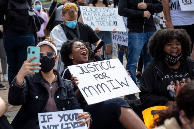 A protester holds a sign calling for justice for missing and murdered Indigenous women at a protest in Vancouver in 2020. (Ben Nelms/CBC - image credit)