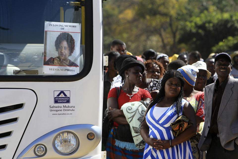 CAPTION CORRECTS SPELLING OF MAPHOSA Relatives wait to board the bus for the burial of Sylvia Maphosa on the outskirts of the capital Harare, Saturday, Aug, 4, 2018. Maphosa was shot and killed by the Army during election related demonstrations in the capital Wednesday. Zimbabwean President elect Emmerson Mnangagwa won an election Friday with just over 50 percent of the ballots as the ruling party maintained control of the government in the first vote since the fall of longtime leader Robert Mugabe (AP Photo/Tsvangirayi Mukwazhi)