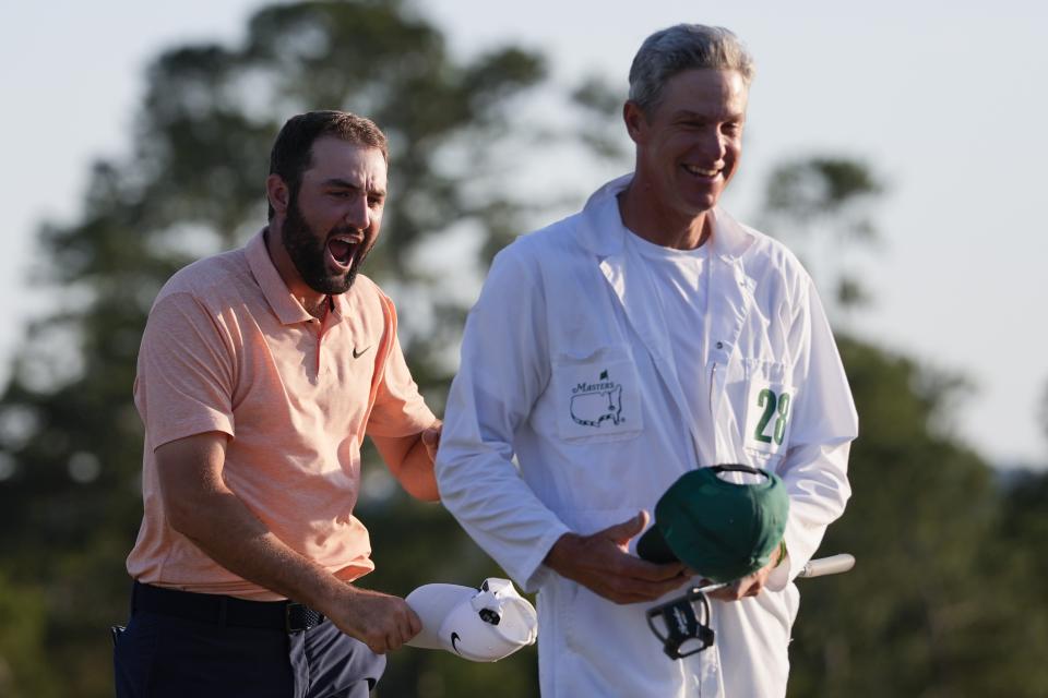 Scottie Scheffler celebrates with his caddie Ted Scott after winning the Masters golf tournament at Augusta National Golf Club Sunday, April 14, 2024, in Augusta, Ga. (AP Photo/David J. Phillip)