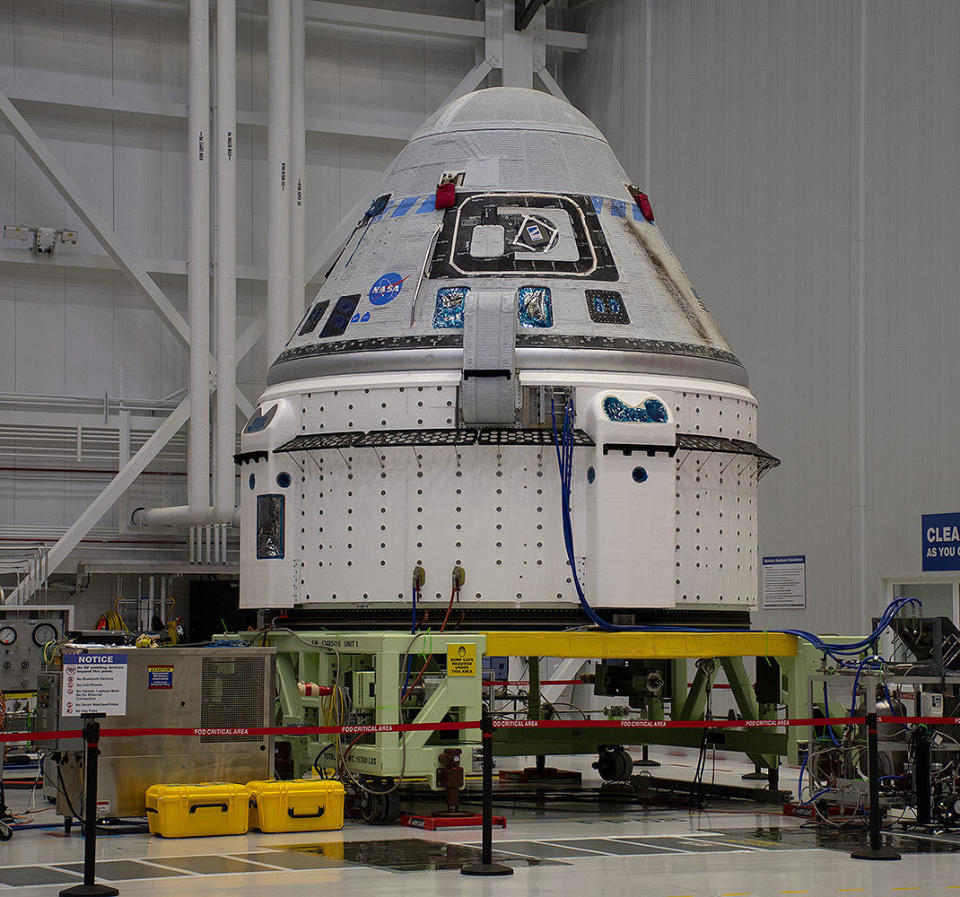 The Starliner capsule in Boeing's processing facility at Kennedy Space Center. The Service Module is the white lower section that houses the critical helium fuel pressurization tanks and plumbing, along with the maneuvering thrusters in the four rectangular engine bays, or 