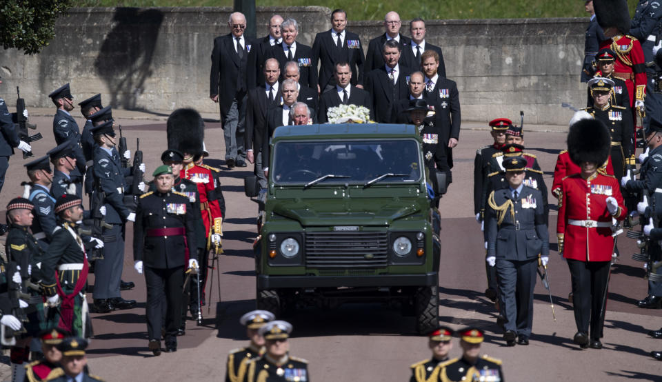 Prince Charles, Prince William, Prince Harry, Timothy Laurence, Princess Anne, Prince Andrew, Prince Edward, David, Earl of Snowdon, Peter Phillips walk behind a Land Rover carrying the coffin of Prince Philip at his funeral on April 17, 2021 in Windsor, England