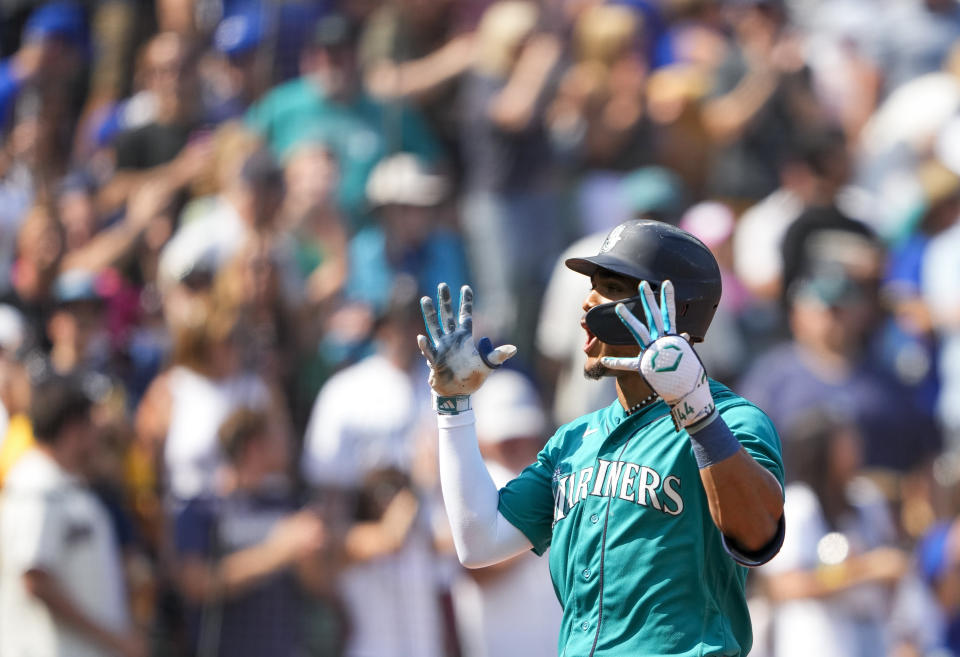 Seattle Mariners' Julio Rodriguez reacts after hitting his 50th career home run, a two-run home run that also scored J.P. Crawford against the Kansas City Royals, during the fifth inning of a baseball game Saturday, Aug. 26, 2023, in Seattle. (AP Photo/Lindsey Wasson)