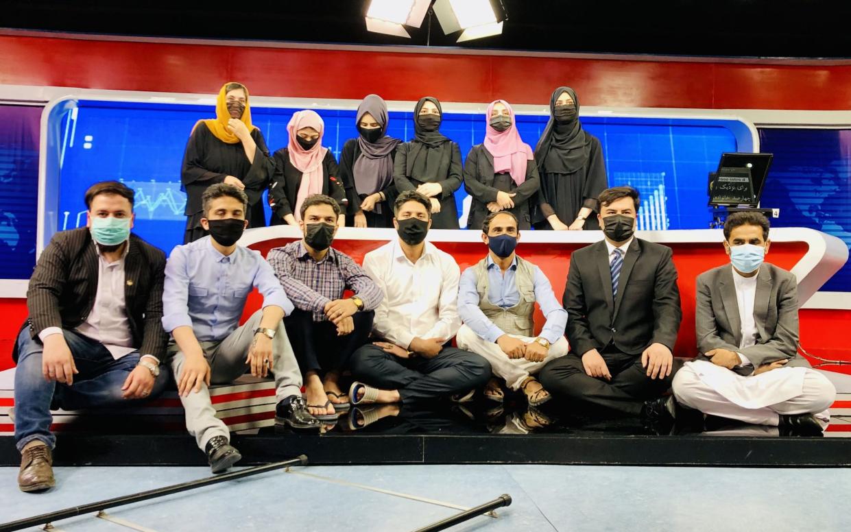 Male staff at Afghanistan's Tolo TV wear face masks to show solidarity with their female colleagues at the Kabul studio - STRINGER /EPA-EFE/Shutterstock 