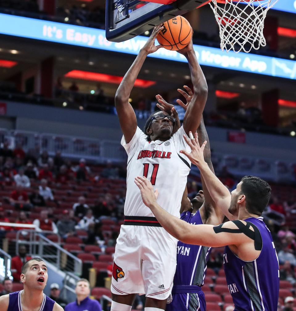 Louisville's Dennis Evans gets fouled by Kentucky Wesleyan's NaVuan Peterson  in the first half. Evans finished with four points, five rebounds and three blocks. Kentucky Wesleyan outrebounded the Cardinals, 47-33.