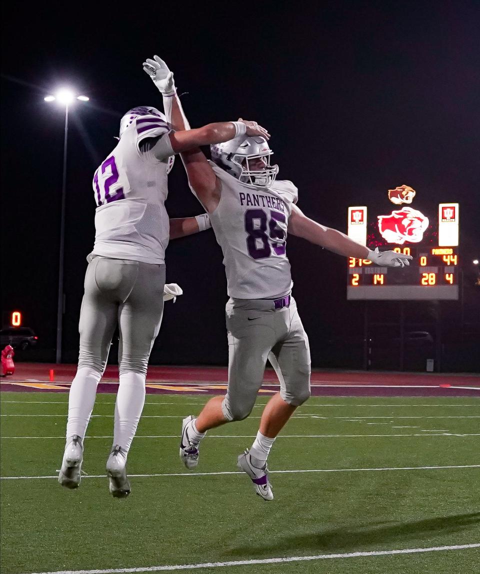 Bloomington South’s Jarrin Alley (12) and Tysen Smith (85) celebrate after defeating Bloomington North in an IHSAA sectional semi-final football game at Bloomington North on Friday, Oct. 27, 2023.