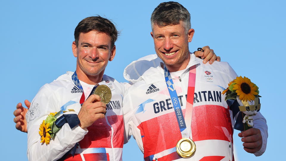 Tokyo 2020 Olympics - Sailing - Men's 49er - Medal Ceremony - Enoshima Yacht Harbour - Tokyo, Japan - August 3, 2021. Gold medallists Dylan Fletcher of Britain and Stuart Bithell of Britain celebrate on the podium. REUTERS/Carlos Barria