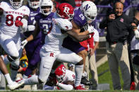 Northwestern running back Evan Hull (26) is tackled by Rutgers linebacker Olakunle Fatukasi during the first half of an NCAA college football game in Evanston, Ill., Saturday, Oct. 16, 2021. (AP Photo/Nam Y. Huh)