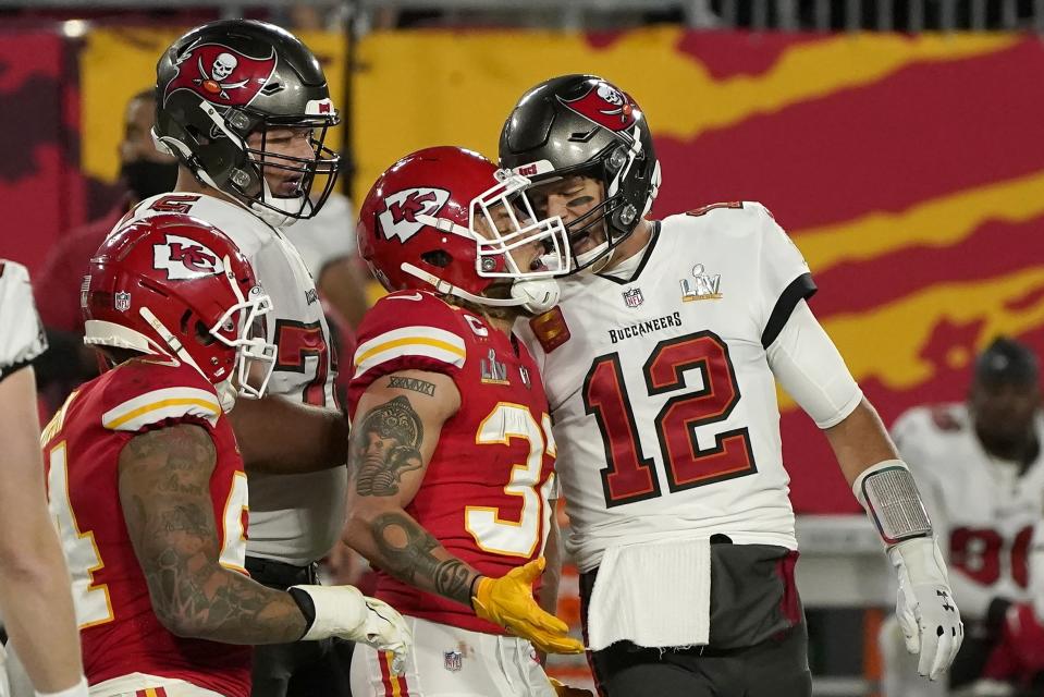 Tampa Bay Buccaneers quarterback Tom Brady (12) talks with Kansas City Chiefs strong safety Tyrann Mathieu (32) after throwing a touchdown pass during the first half of the NFL Super Bowl 55 football game Sunday, Feb. 7, 2021, in Tampa, Fla. (AP Photo/Gregory Bull)