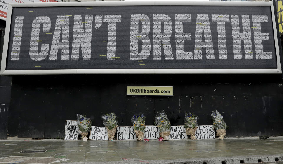 A billboard with a memorial of flowers which was unveiled by UK's Black Lives Matter ahead of expected rival demonstrations by anti-racism and far-right protesters in London, Friday, June 12, 2020 in response to the recent killing of George Floyd by police officers in Minneapolis, USA, that has led to protests in many countries and across the US.(AP Photo/Matt Dunham)