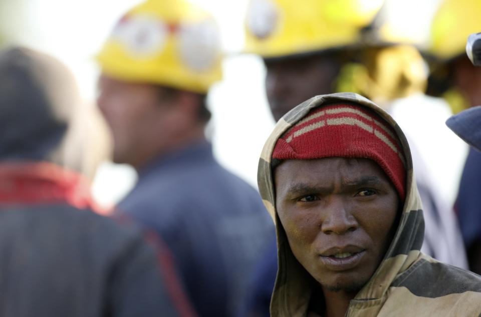 A suspected illegal miner talks to officials after being rescued from an abandoned gold shaft in Benoni