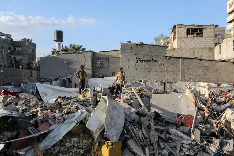 People search through buildings that were destroyed during Israeli air raids in the southern Gaza Strip (Getty Images)