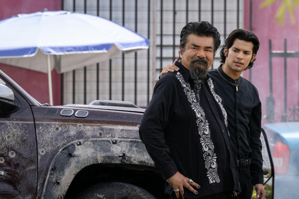 (L To R) George Lopez As Uncle Rudy And Xolo Maridueña As Jaime Reyes in Blue Beetle. (Warner Bros.)