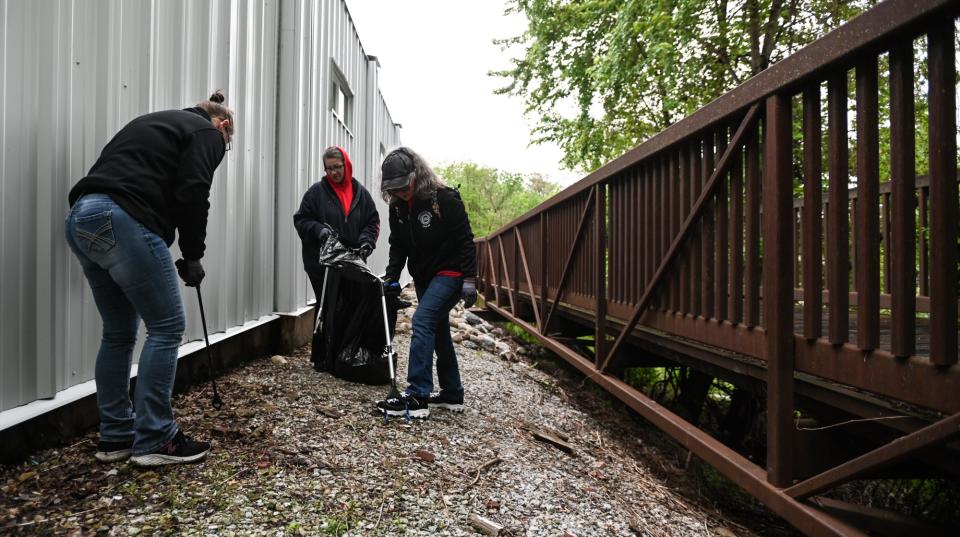 Members of the UAW Local 602 pick up debris along the Grand River, Saturday morning, May 11, 2024, as part of the 30th Annual BWL Adopt a River cleanup.