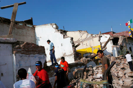 People work on a house damaged in an earthquake that struck the southern coast of Mexico late on Thursday, in Juchitan, Mexico, September 9, 2017. REUTERS/Carlos Jasso