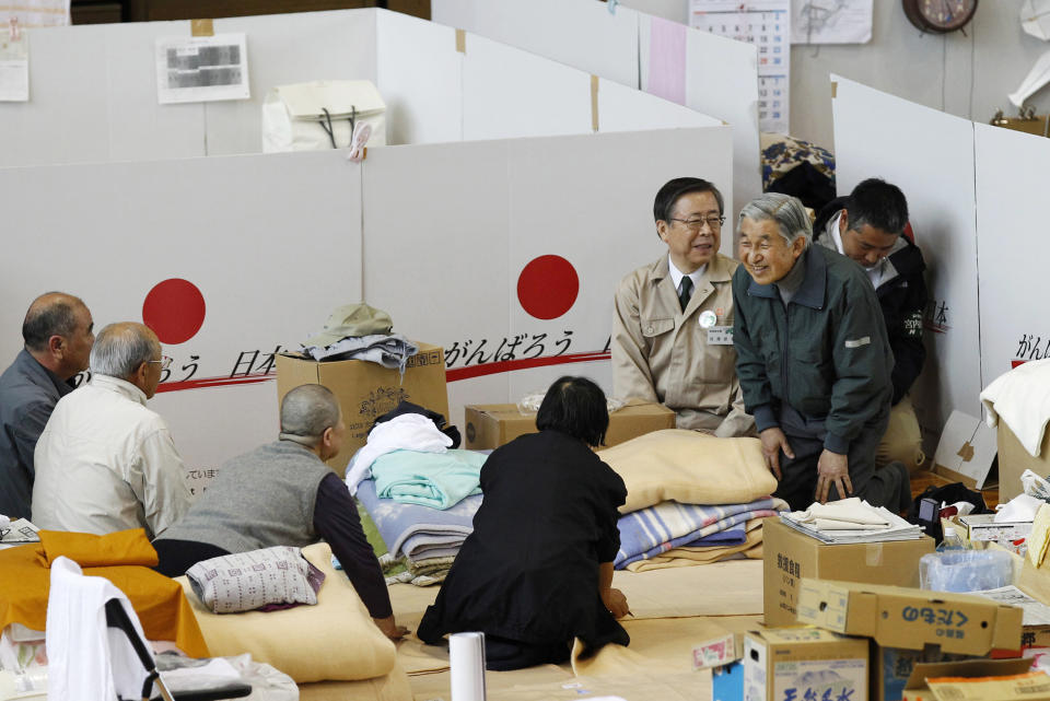 FILE - In this May 11, 2011, file pool photo, Japan's Emperor Akihito, right, talks to evacuees at a shelter for people who fled their houses because of radiation fear by the March 11 tsunami-crippled Fukushima Dai-ichi nuclear power plant in Fukushima, northeastern Japan. Japan’s Emperor Akihito has devoted his 30-year reign to making amends for a war fought in his father’s name, while adapting the 1,500-year-old monarchy’s traditions to draw the Imperial Family closer to the public. Akihito’s subtle public comments and insights from his classmates show him to be determined but also open to new ideas. He’s shown a keen awareness of his duties. (AP Photo/Shizuo Kambayashi, File)