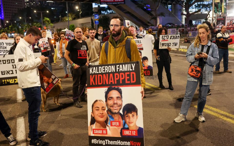 Families of Israeli hostages protest outside the ministry of defence in Tel Aviv calling for their release