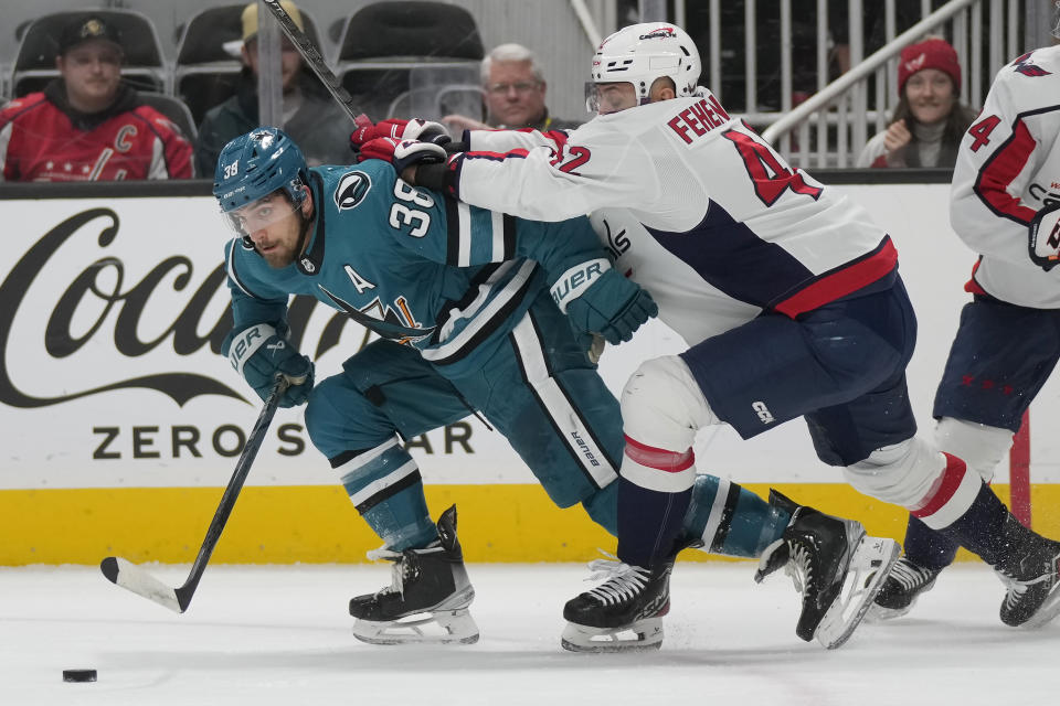 San Jose Sharks defenseman Mario Ferraro (38) skates toward the puck in front of Washington Capitals defenseman Martin Fehervary during the first period of an NHL hockey game in San Jose, Calif., Monday, Nov. 27, 2023. (AP Photo/Jeff Chiu)