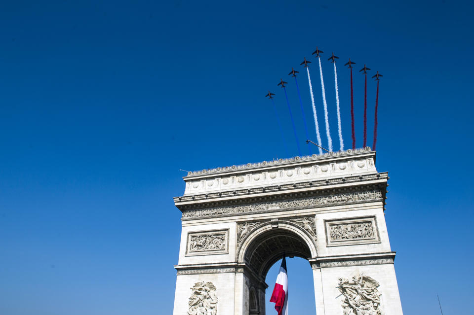 The Patrouille de France military aerobatics team fly over the Arc de Triomphe during the Bastille Day parade in Paris, Sunday, July 14, 2013. Troops from 13 African countries who backed France in a war against al-Qaida-linked extremists in Mali marched with the French military during the Bastille Day parade in Paris on Sunday to honor their role in the conflict. (AP Photo/Martin Bureau, Pool)