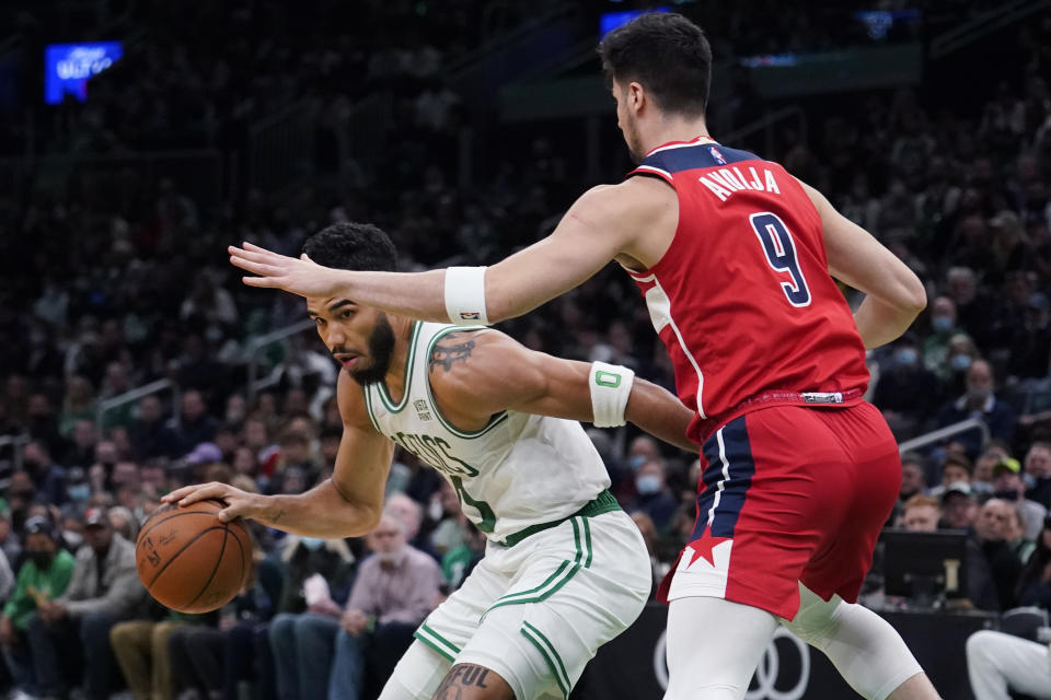 Boston Celtics forward Jayson Tatum (0) tries to drive past Washington Wizards forward Deni Avdija (9) during the first half of an NBA basketball game, Wednesday, Oct. 27, 2021, in Boston. (AP Photo/Charles Krupa)