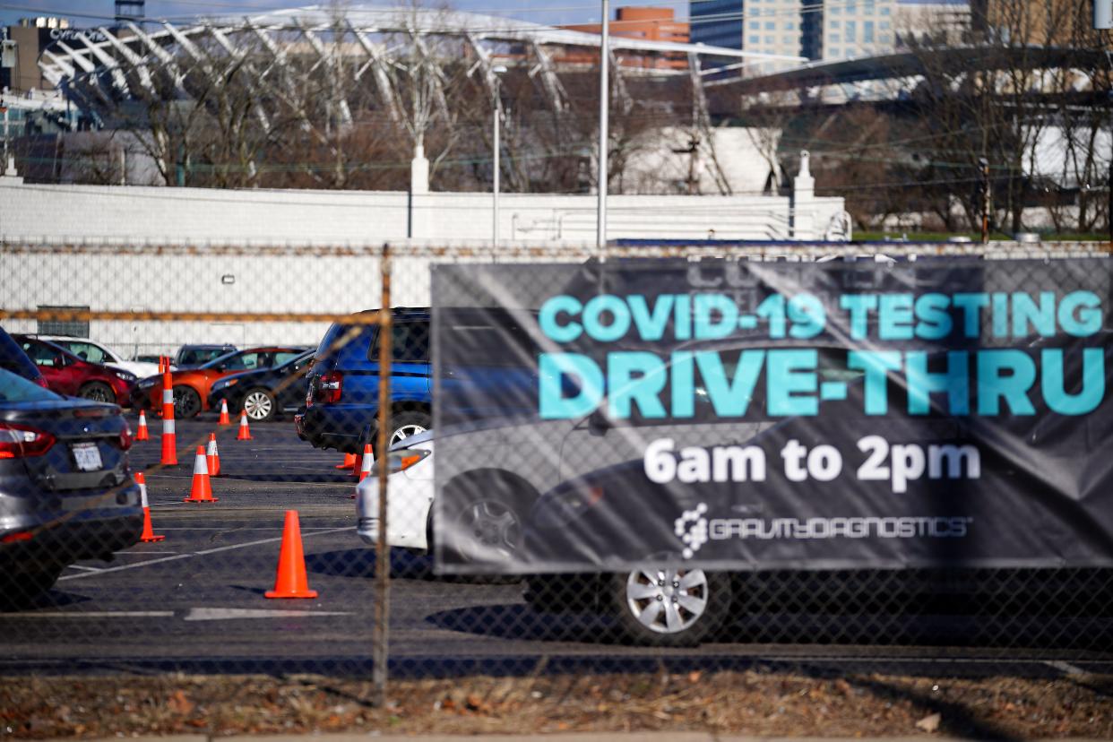 People line up in their cars and wait for a drive-thru COVID-19 test, Wednesday, Jan. 5, 2022, at the Gravity Diagnostics COVID-19 testing site in Covington, Ky. The latest wave of the pandemic, fueled by the omicron variant, continues to push hospital and testing capacity.