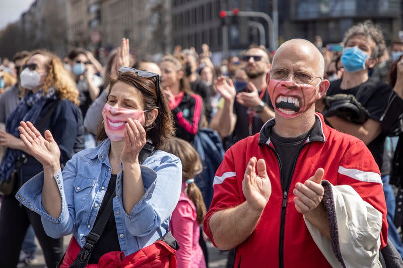 People attend a protest in front of the Serbian parliament in Belgrade