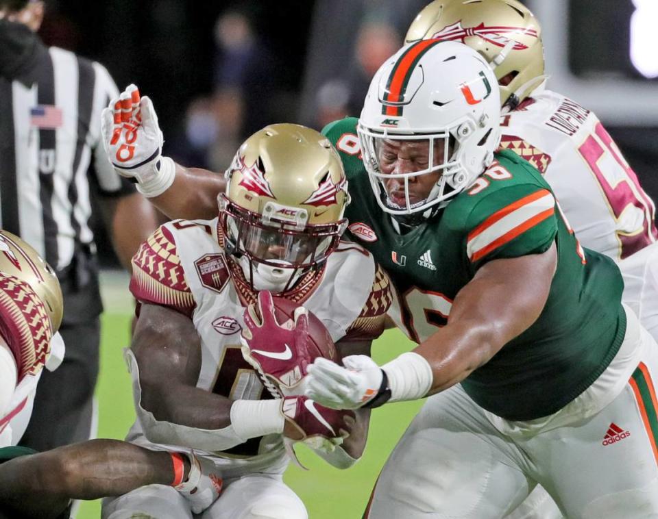 UM’S offensive lineman Jonathan Ford (96) sacks FSU’s James Blackman (0) in the second quarter as the University of Miami host Florida State University Seminoles at Hard Rock Stadium in Miami Gardens on Saturday, September 26, 2020.