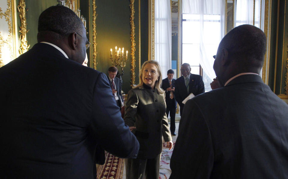 U.S. Secretary of State Hillary Rodham Clinton meets members of Nigeria's delegation at the London Conference on Somalia, Thursday Feb. 23, 2012. World leaders pledged new help to Somalia to tackle terrorism and piracy, but insisted Thursday that the troubled east African nation must quickly install a permanent government and threatened penalties against those who hamper political progress. (AP Photo/Jason Reed, Pool)