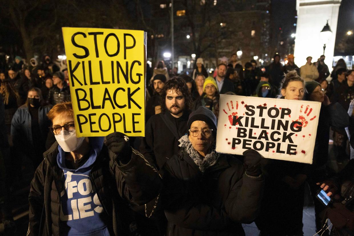 Demonstrators hold signs during a protest at Washington Square Park in New York on 28 January 2023, in response to the death of Tyre Nichols, who died after being beaten by Memphis police during a traffic stop (AP)