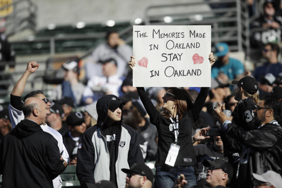 An Oakland Raiders fans holds up a sign during the first half of an NFL football game against the Jacksonville Jaguars in Oakland, Calif., Sunday, Dec. 15, 2019. (AP Photo/Ben Margot)