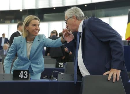 European Commission President Jean-Claude Juncker (R) greets European Union foreign policy chief Federica Mogherini ahead of a debate on The State of the European Union at the European Parliament in Strasbourg, France, September 14, 2016. REUTERS/Vincent Kessler