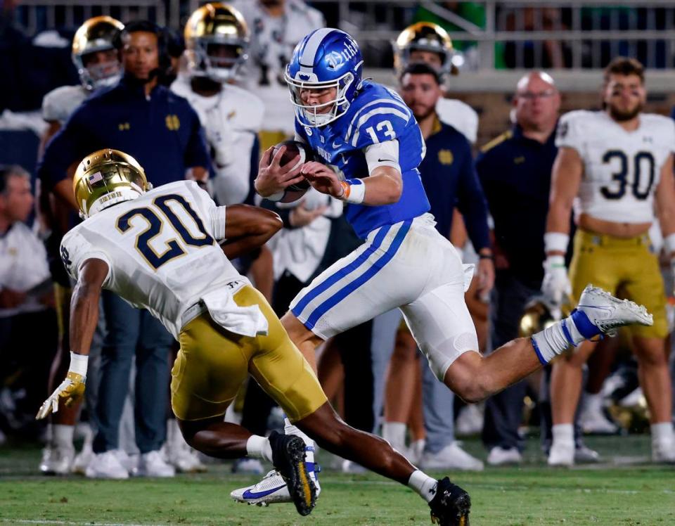 Duke’s Riley Leonard runs the ball past Notre Dame’s Benjamin Morrison during the second half of the Blue Devils’ 21-14 loss at Wallace Wade Stadium on Saturday, Sept. 30, 2023, in Durham, N.C.