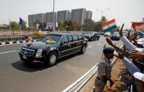 People wave as a motorcade transporting U.S. President Donald Trump passes enroute to Sardar Patel Stadium in Ahmedabad, India, February 24, 2020. REUTERS/Amit Dave