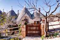 <p>Globe trotters will have to book flights to Italy for a chance to stay in the world’s most popular Airbnb. For £64 per night, guests can reside at Sette Coni – which translates to the seven cones – in Ostuni. The stone cottage is located near to must-see tourist hotspots such as the caves of Castellana, the cities of Lecce and Martina Franca and the excavations of Egnazia.<br>According to the listing, it’s a perfect location for nature lovers with a traditional patio area sitting pretty beneath an olive tree – we challenge you to find a greater location to read your new book. Don’t believe us? A grand total of 164,444 Airbnb users have wish listed the property so far. <strong><a rel="nofollow noopener" href="https://www.airbnb.co.uk/rooms/432044" target="_blank" data-ylk="slk:Book now" class="link rapid-noclick-resp">Book now</a></strong>. <em>[Photo: Caters]</em> </p>
