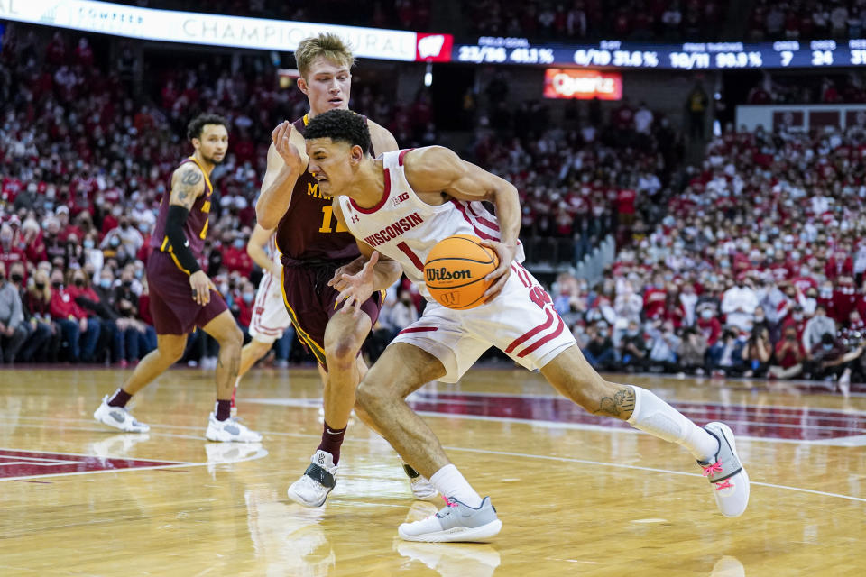 Wisconsin's Johnny Davis (1) drives against Minnesota's Jackson Purcell (11) during the second half of an NCAA college basketball game Sunday, Jan. 30, 2022, in Madison, Wis. Wisconsin won 66-60. (AP Photo/Andy Manis)
