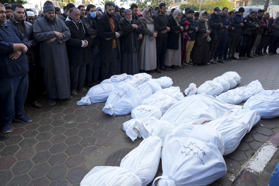 Palestinians mourn their relatives killed in the Israeli bombardment of the Gaza Strip in Deir al Balah, Monday, Feb. 5, 2024. (AP Photo/Adel Hana)