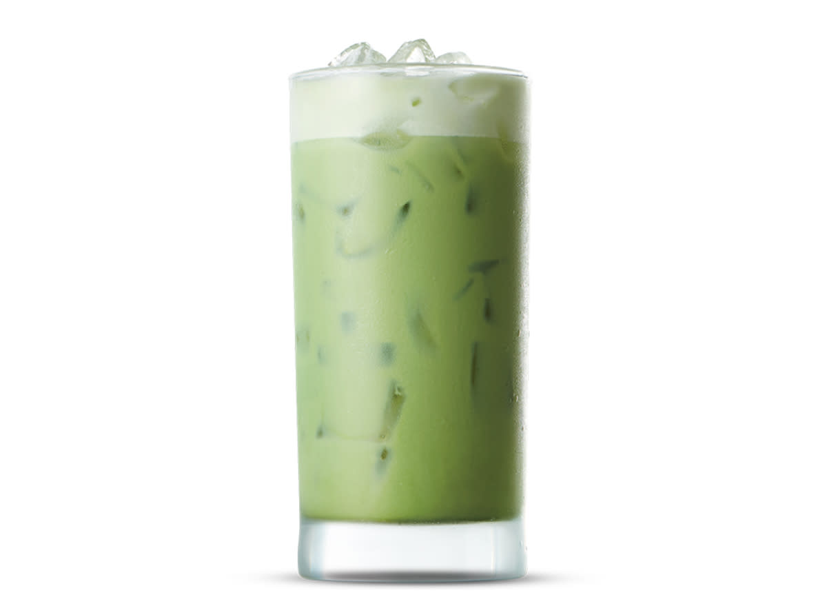 glass of caribou coffee's iced matcha vanilla tea latte