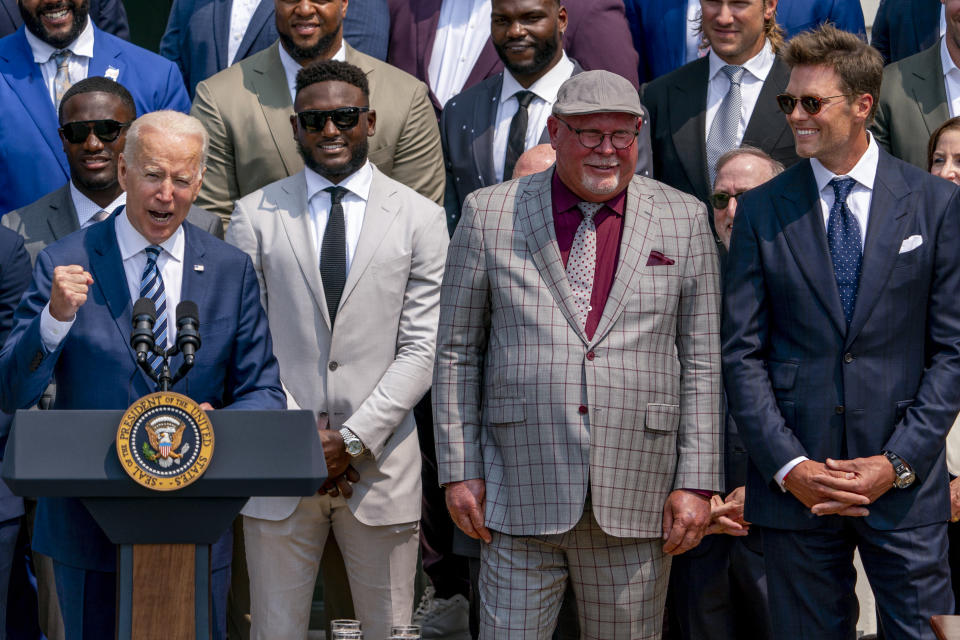 President Joe Biden, surrounded by members of the Tampa Bay Buccaneers, including Tampa Bay Buccaneers head coach Bruce Arians, second from right, and Tampa Bay Buccaneers quarterback Tom Brady, right, speaks during a ceremony on the South Lawn of the White House in Washington, Tuesday, July 20, 2021, where the president honored the Super Bowl Champion Tampa Bay Buccaneers for their Super Bowl LV victory. (AP Photo/Andrew Harnik)