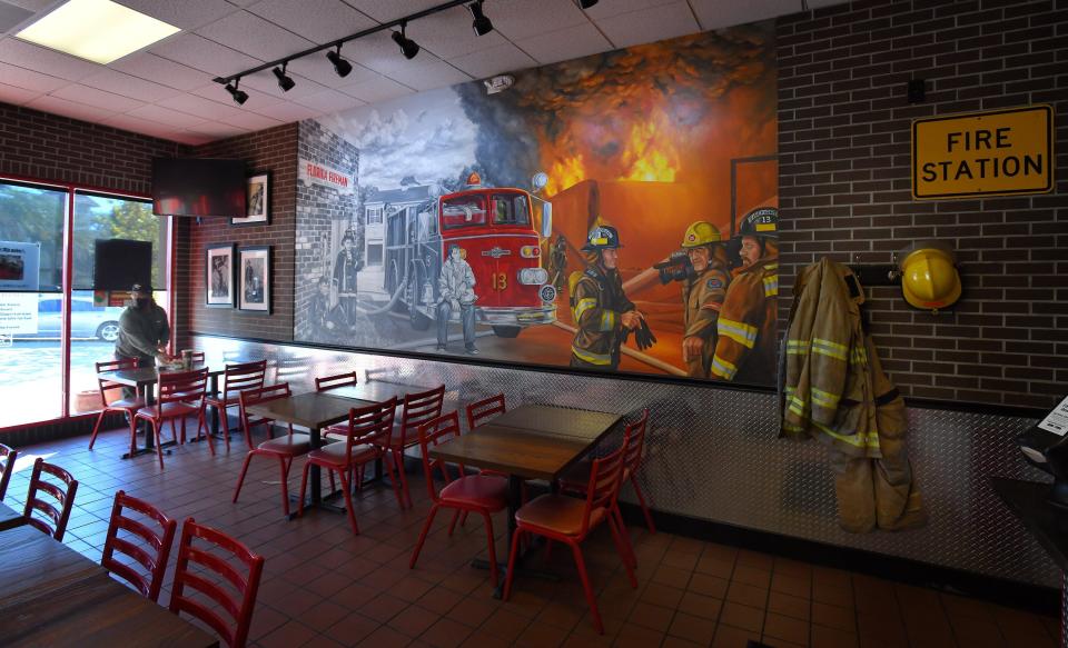 Each Firehouse Subs restaurant features a mural. In this one at the chain's historic San Marco Square location, the mural depicts former Jacksonville firefighters Captain Rob Sorensen with his two sons, Chris, left, and Robin Sorensen, founders of the restaurant chain.