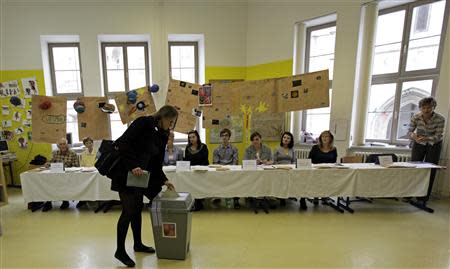 A woman casts her vote at a polling station during an early general election in Brno October 25, 2013. REUTERS/David W Cerny