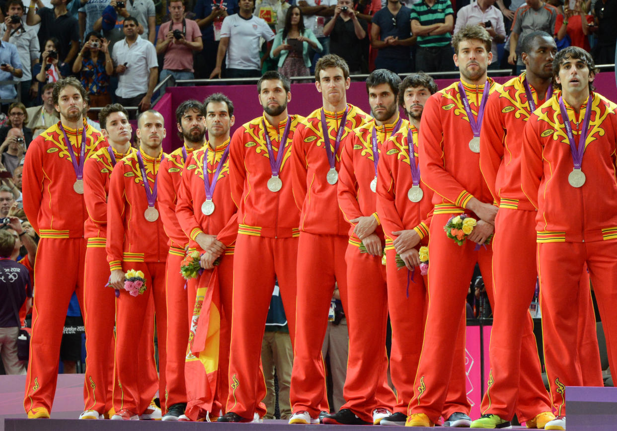 Spain's players pose on the podium after winning the silver medal in the London 2012 Olympic Games men's basketball competition at the North Greenwich Arena in London on August 12, 2012. The US won the gold medal followed by the silver to Spain and the bronze to Russia. AFP PHOTO /MARK RALSTON        (Photo credit should read MARK RALSTON/AFP/GettyImages)