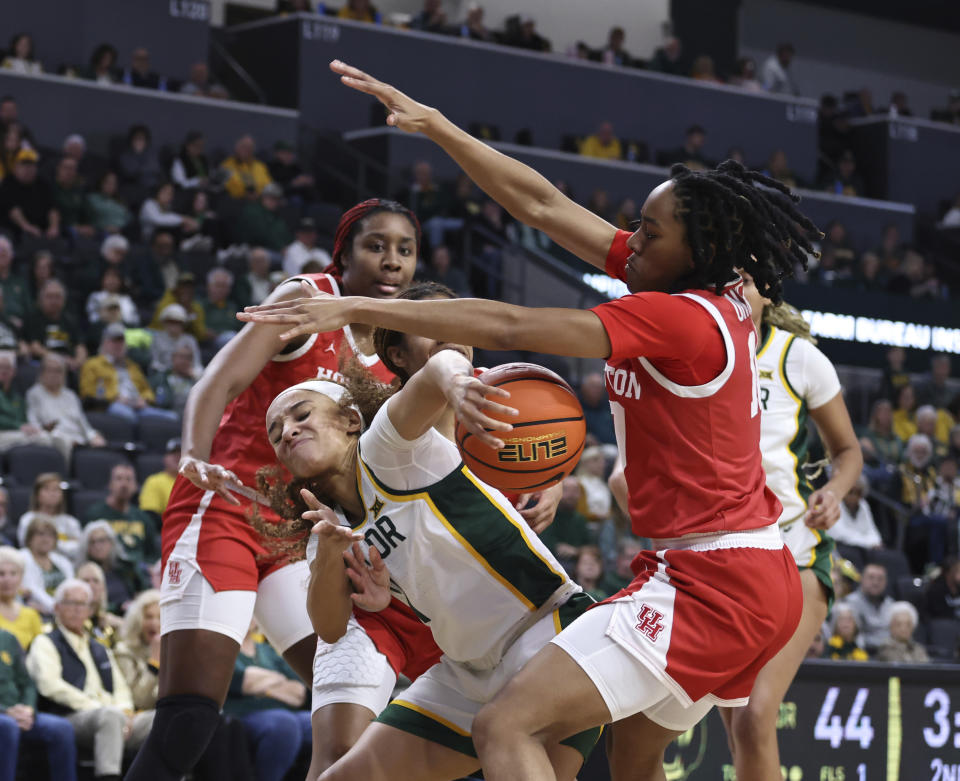 Baylor guard Jada Walker tries to hang on to the ball while being pressured by Houston guard Britney Onyeje in the first half of an NCAA college basketball game, Saturday, Jan. 6, 2024, in Waco, Texas. (Rod Aydelotte/Waco Tribune-Herald via AP)