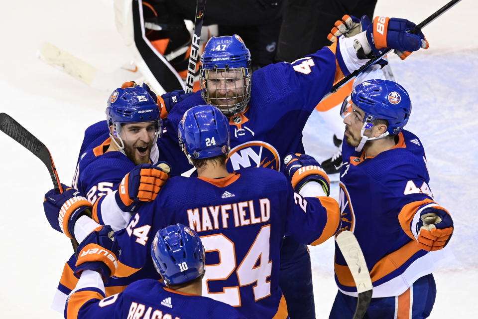 New York Islanders center Leo Komarov (47) celebrates his goal against the Philadelphia Flyers with teammates during second-period NHL Stanley Cup Eastern Conference playoff hockey game action in Toronto, Saturday, Aug. 29, 2020. (Frank Gunn/The Canadian Press via AP)