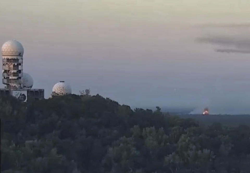 This video still image shows an explosion at a blasting site inside the Grunewald forest in Berlin, Germany, Thursday, Aug. 4, 2022. A large fire has broke out in one of Berlin's biggest forests triggered by several explosions that took place on a blasting site inside the forest leading to canceled public transportation and the closure of several roads. (Michael von Rein, Haustechnik - Corbusierhaus via AP)